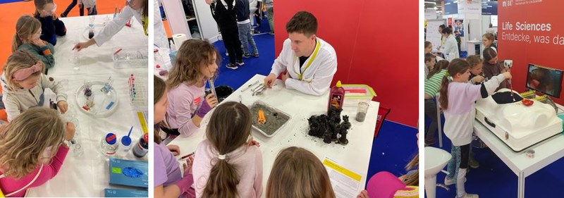 Mehrere Kinder stehen um einen Tisch und arbeiten/basteln/experimentieren mit einer Person im weissen Kittel der Life Sciences.