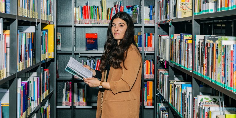 student in a library acquiring interdisciplinary skills
